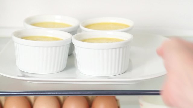 Creme caramel being place in the fridge