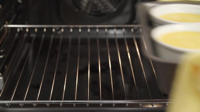 Creme caramel being removed from the oven