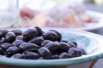 Black olives in a ceramic bowl