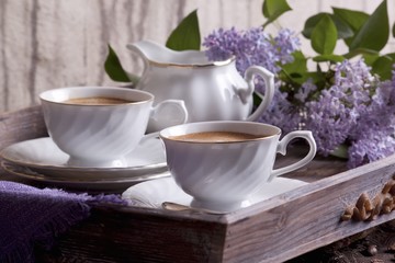 Cups of coffee and a jug of milk