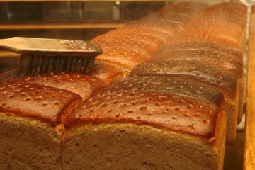 Brown bread in an oven being brushed with water