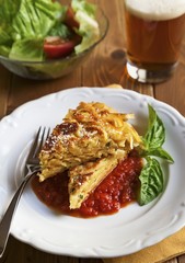 Serving of Pan Fried Fettuccine Pie with Tomato Sauce; Salad and Beer