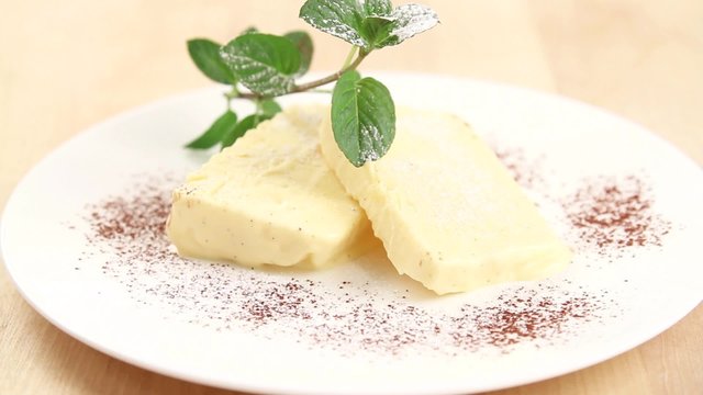Vanilla parfait being dusted with icing sugar
