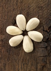 Almonds, skinned, on a wooden surface