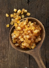 Candied orange peel in a wooden spoon