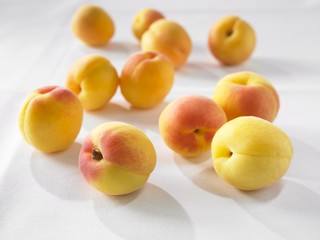Apricots on a white surface