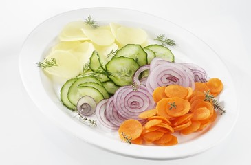 Potatoes, cucumber, onions and carrots cut into slices