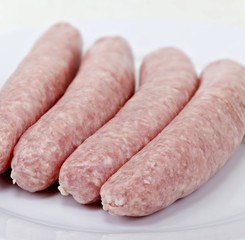 Four raw pork sausages