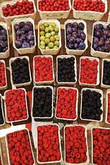 Raspberries, blackberries, cornel cherries, plums and mirabelle plums in cardboard punnets