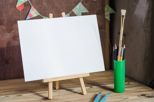 Art supplies. Brushes, easel, paper. Place for your text. Mock up photography.