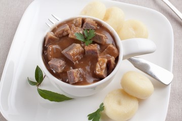 Goulash of goose with potato dumplings