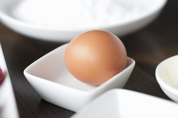 A brown egg in a small dish