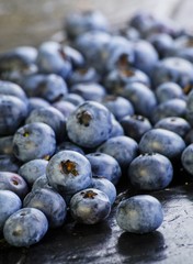 Lots of blueberries on a slate slab
