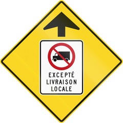 Warning road sign in Quebec, Canada - Lorry prohibition ahead. The text means: Except local delivery