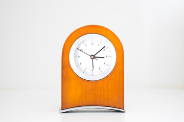 Brown wood clock on white background