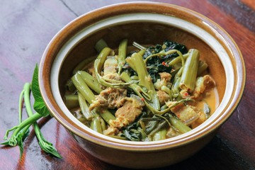 Streaky pork in sour red curry with water spinach (Morning Glory), Thai food.