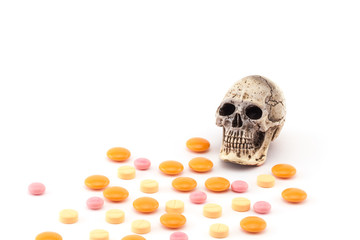 Human skull and drugs on isolated white background.