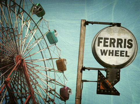 aged and worn vintage photo of ferris wheel and sign