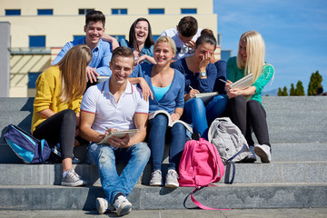 students outside sitting on steps