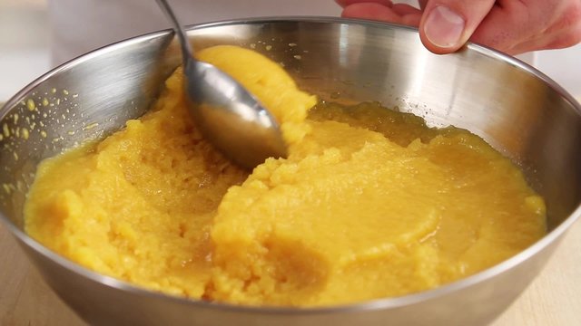 Passion fruit sorbet being scooped out with a spoon
