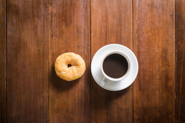 donuts and Coffee cup on wooden background, top view