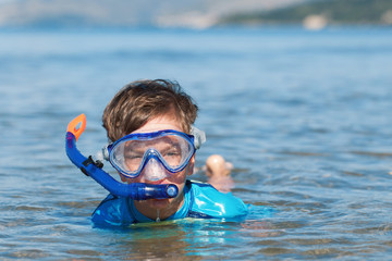 Portrait of happy cute boy wearing snorkeling mask