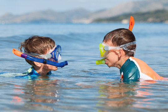 Portrait of happy cute boys wearing snorkeling mask