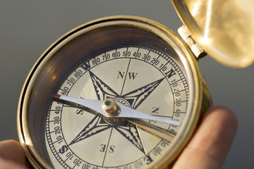 Man holding compass for direction