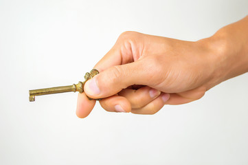 The hand of a man is holding a key