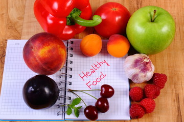 Fruits and vegetables with notebook, slimming and healthy food