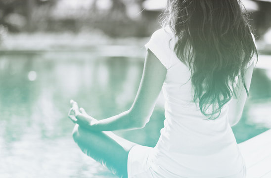 Slim Woman Meditating at the Poolside - Powered by Adobe