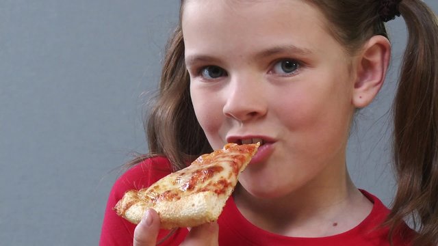 Girl eating a slice of pizza