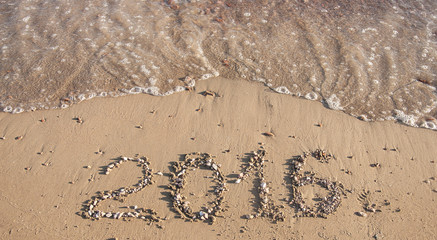 2016 written in sand on sunny beach