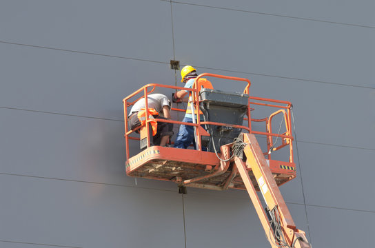 Workers in lifting cage