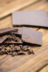 Pieces of chocolate on a wooden table