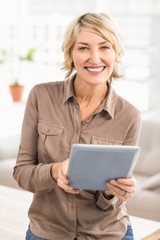 Smiling casual businesswoman with tablet