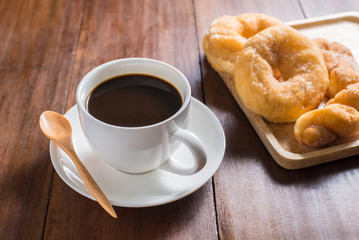 donuts and Coffee cup on wooden background