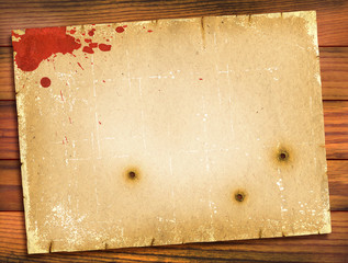 Old paper texture with red blood on wood background.Retro