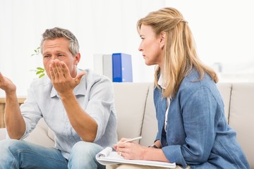 Therapist listening to male patients worries