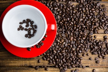 Coffee beans on a table with cup