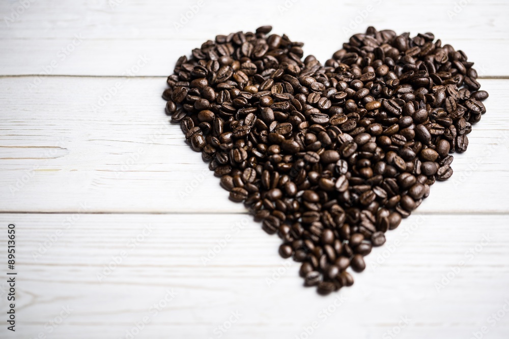 Poster coffee beans on a table in heart shape