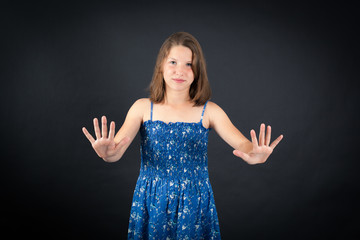 Beautiful girl doing different expressions in different sets of clothes: stop sign