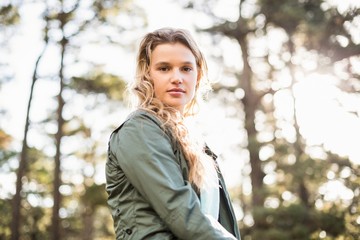 Young jogger sitting on rock and looking at camera