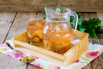 Gooseberry compote in a jar on a wooden tray