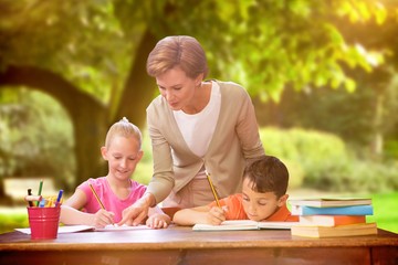 Composite image of teacher helping pupils in library