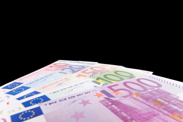 Various euro notes isolated on black background