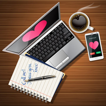 booklet and laptop with mobile phone and coffee cup