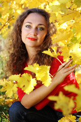 Naklejka na ściany i meble Girl with curly hair in yellow grape vineyard, autumn time