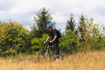 Fototapeta premium Biking in the Franconian Hills in Northern Bavaria. Young man on