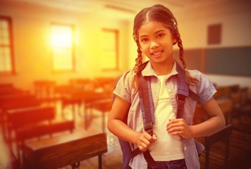 Composite image of cute pupil smiling at camera